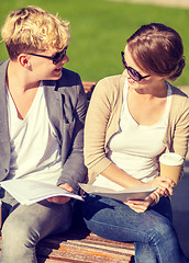 Image showing two students with books, notebooks and folders