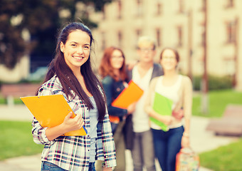 Image showing smiling female student with folders