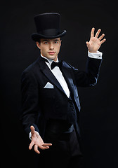 Image showing magician in top hat showing trick