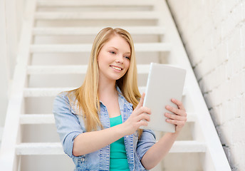 Image showing smiling female student with tablet pc computer