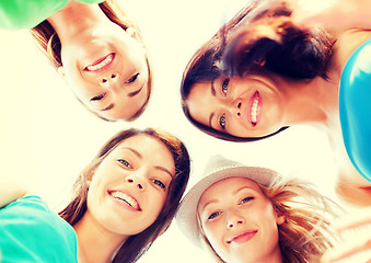 Image showing faces of girls looking down and smiling