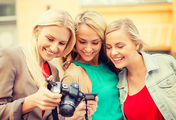 Image showing beautiful blonde women with camera in the city