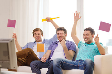 Image showing happy male friends with flags and vuvuzela