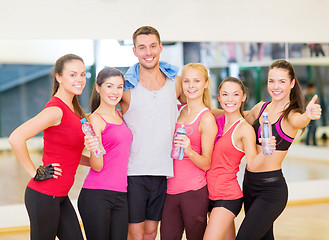 Image showing group of happy people in gym with water bottles