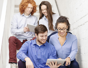 Image showing team with tablet pc computer sitting on staircase