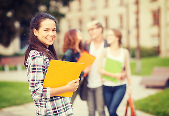 Image showing teenage girl with folders and mates on the back