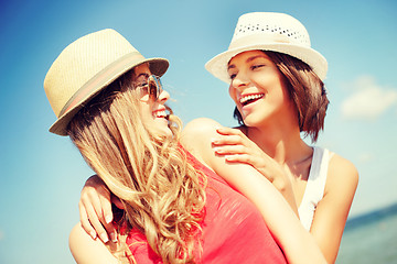 Image showing girls in hats on the beach