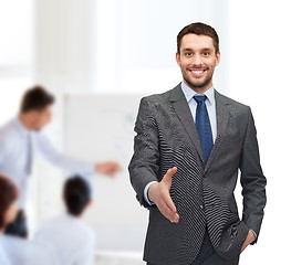 Image showing businessman with open hand ready for handshake