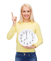 Image showing student with wall clock and finger up