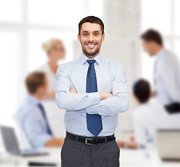 Image showing handsome businessman with crossed arms