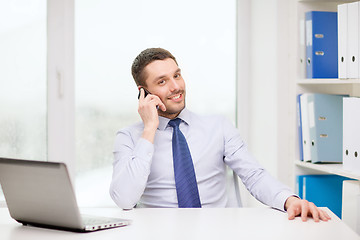 Image showing businessman with laptop and smartphone at office