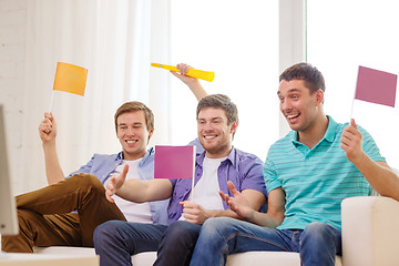 Image showing happy male friends with flags and vuvuzela