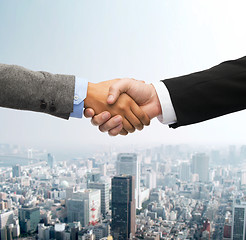 Image showing businessman and businesswoman shaking hands