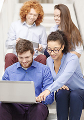 Image showing team with laptop and tablet pc on staircase