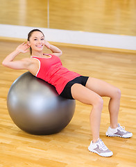 Image showing young woman doing exercise on fitness ball