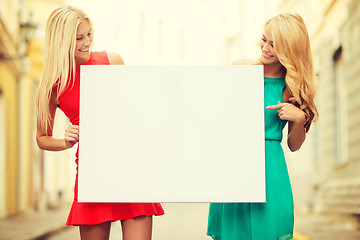 Image showing two happy blonde women with blank white board