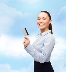 Image showing smiling businesswoman showing credit card