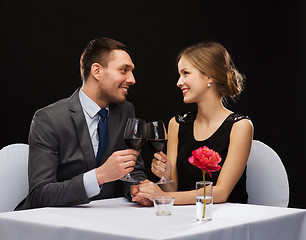 Image showing young couple with glasses of wine at restaurant