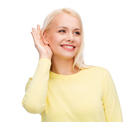 Image showing smiling young woman listening to gossip