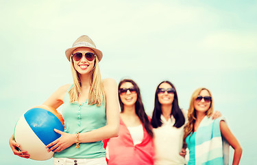 Image showing girl with ball and friends on the beach