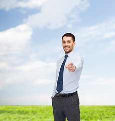 Image showing handsome businessman pointing finger at you