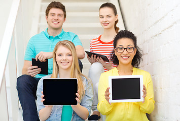 Image showing smiling students showing tablet pc blank screen