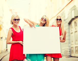 Image showing three happy blonde women with blank white board