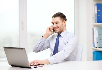 Image showing businessman with laptop and smartphone at office