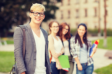 Image showing teenage boy with classmates on the back