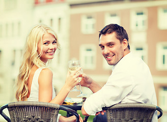 Image showing smiling couple drinking wine in cafe