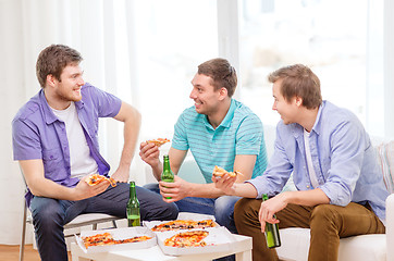 Image showing smiling friends with beer and pizza hanging out