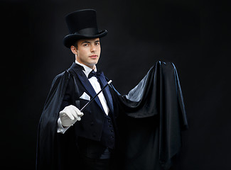 Image showing magician in top hat with magic wand showing trick