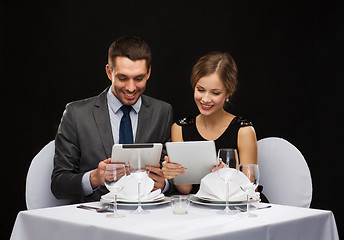 Image showing couple with menus on tablet pc at restaurant