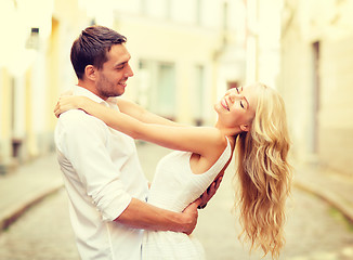 Image showing smiling couple dancing in the city