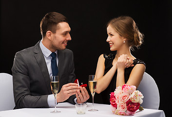 Image showing man proposing to his girlfriend at restaurant