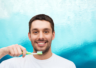 Image showing smiling young man with toothbrush