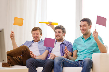 Image showing happy male friends with flags and vuvuzela