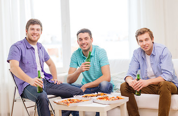 Image showing smiling friends with beer and pizza hanging out