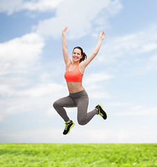 Image showing sporty teenage girl jumping in sportswear