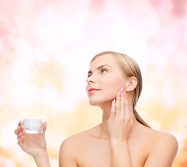 Image showing woman applying cream on her skin