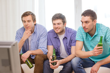 Image showing happy male friends with beer watching tv at home