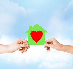 Image showing couple hands holding green paper house