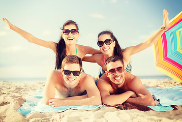 Image showing group of smiling people having fun on the beach