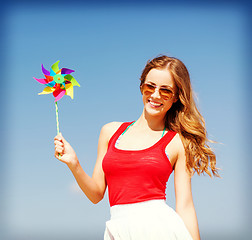 Image showing girl with windmill toy on the beach