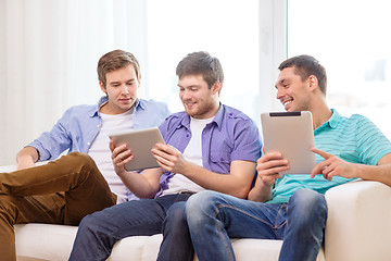 Image showing smiling friends with tablet pc computers at home