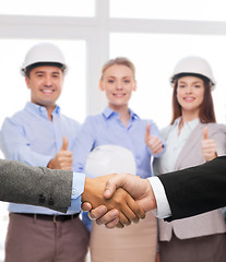 Image showing businessman and businesswoman shaking hands