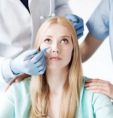 Image showing plastic surgeon and nurse with patient