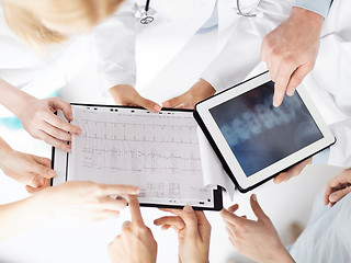 Image showing group of doctors looking at x-ray on tablet pc