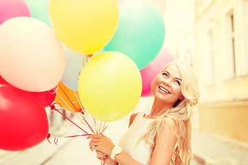 Image showing smiling woman with colorful balloons