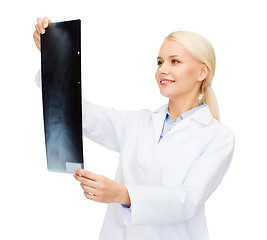 Image showing smiling female doctor looking at x-ray